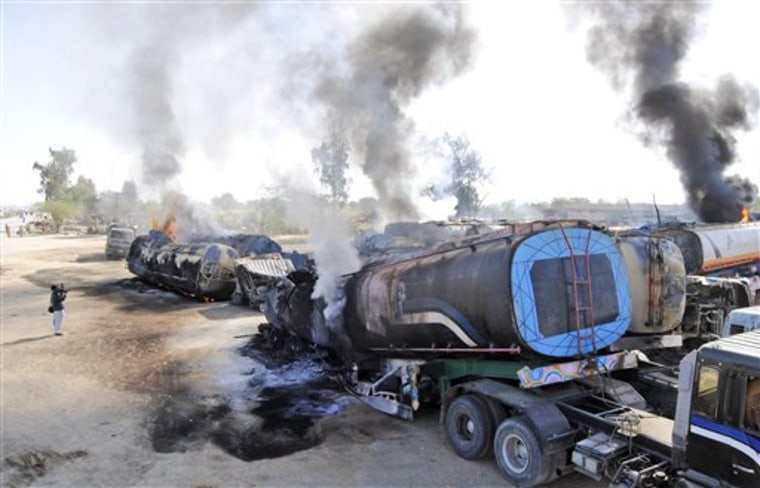 A Pakistani cameraman films burning oil tankers after gunmen attacked a terminal in Dera Murad Jamali southwest Pakistan on Saturday. A government official says gunmen in Pakistan's southwest have set ablaze 14 tankers carrying fuel for U.S. and NATO troops in Afghanistan. A driver also was wounded during the Saturday attack. 